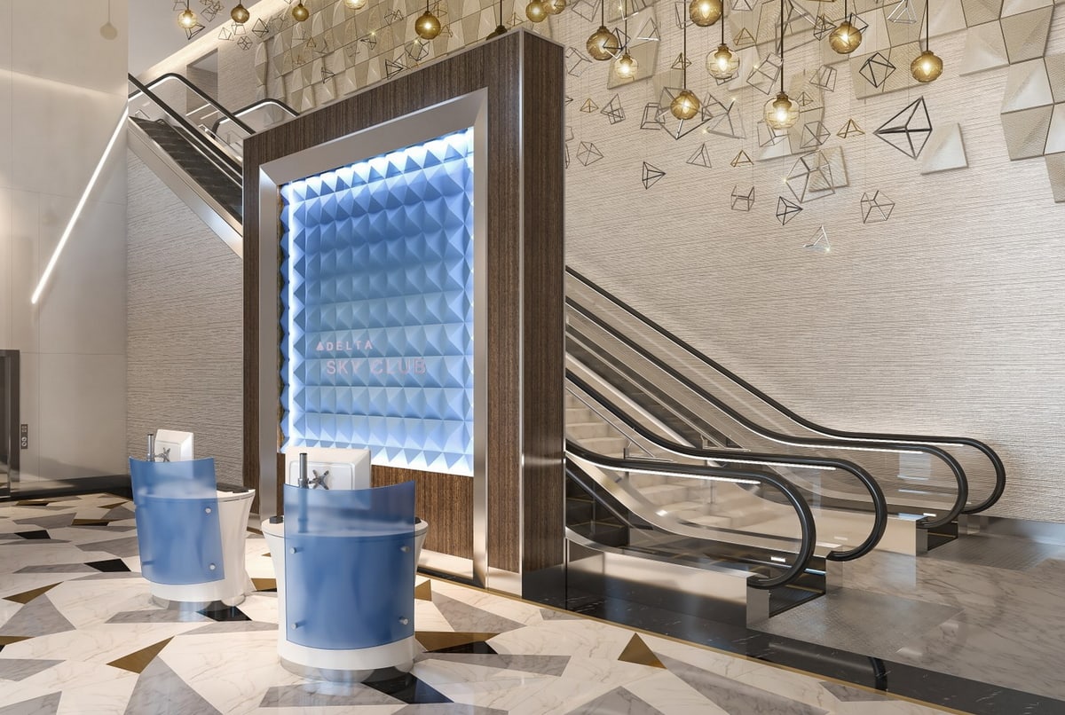Entrance with marble floor to a Delta Sky Club with a check-in desk and escalators in the background.