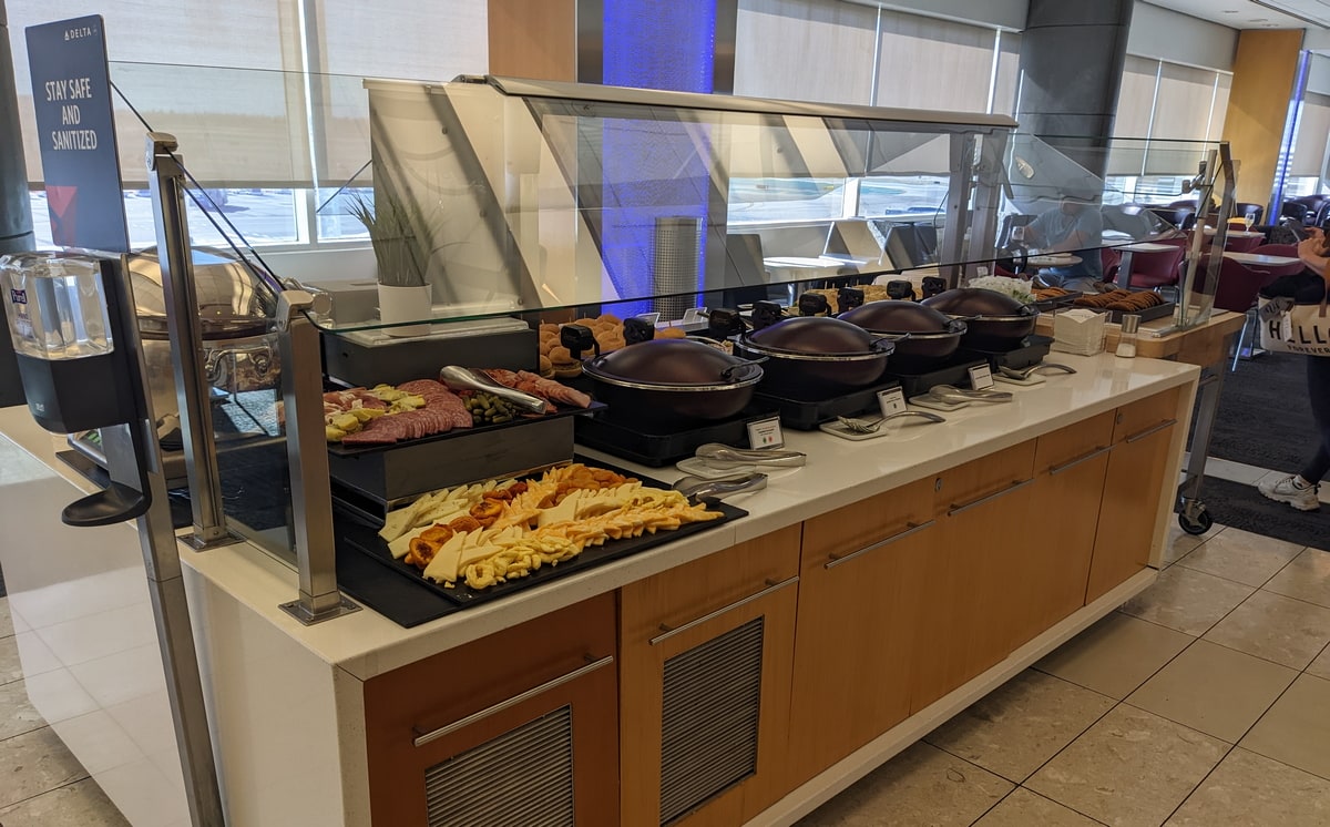 full buffet with warm food and cheese.