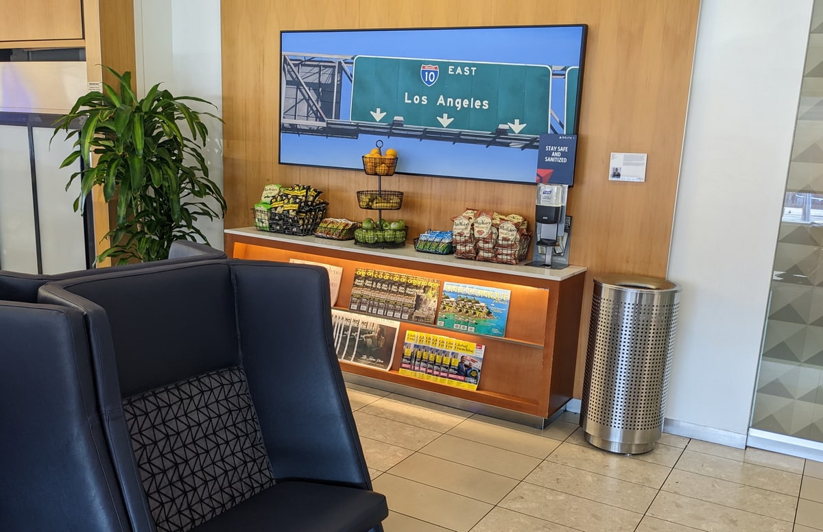 wall art with a table full of snacks and magazines.