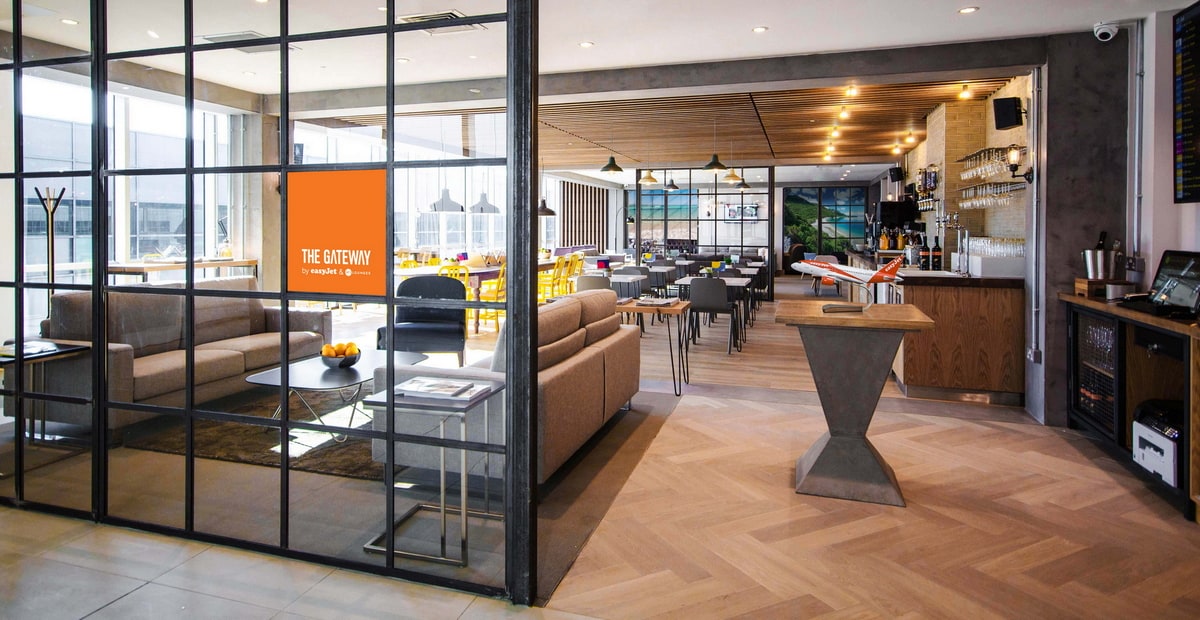 View inside the Gateway Lounge with sofas and tables.