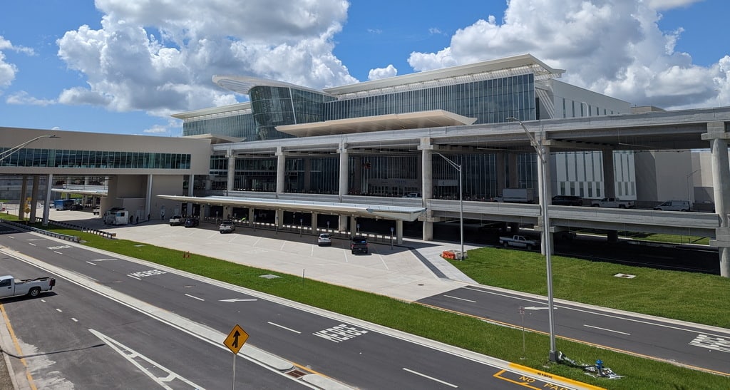 View of the front of Terminal C at Orlando Airport, showing building and access roads.
