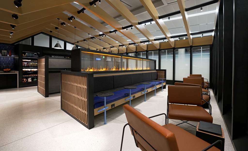 view inside the United Club Fly, showing fireplace and some chairs.