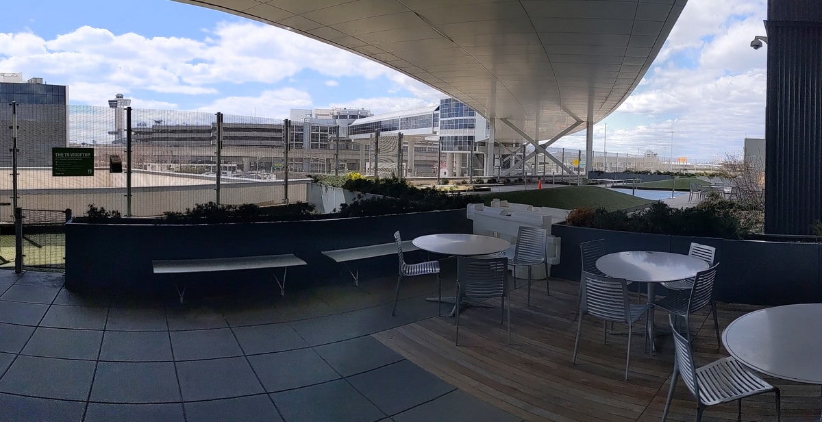 View of the Wooftop Paito at JFK, with tables and chairs.