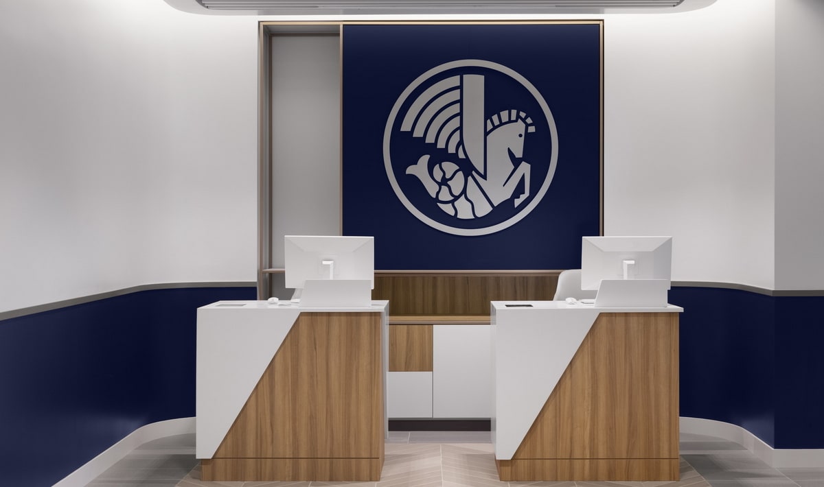 entrance and reception desk with two monitors, and an Air France logo on the back wall.