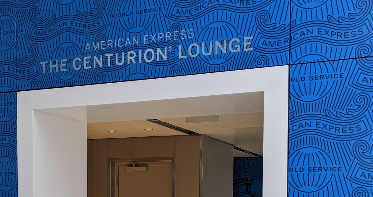 Entrance of an American Express Centurion Lounge with blue backgound.