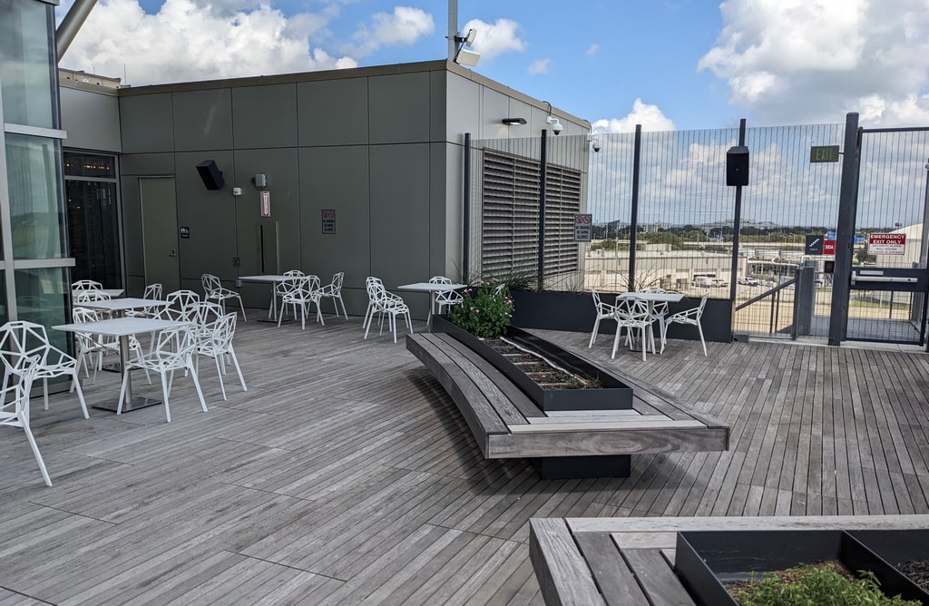 seating, with tables and wood deck on the outdoor patio.