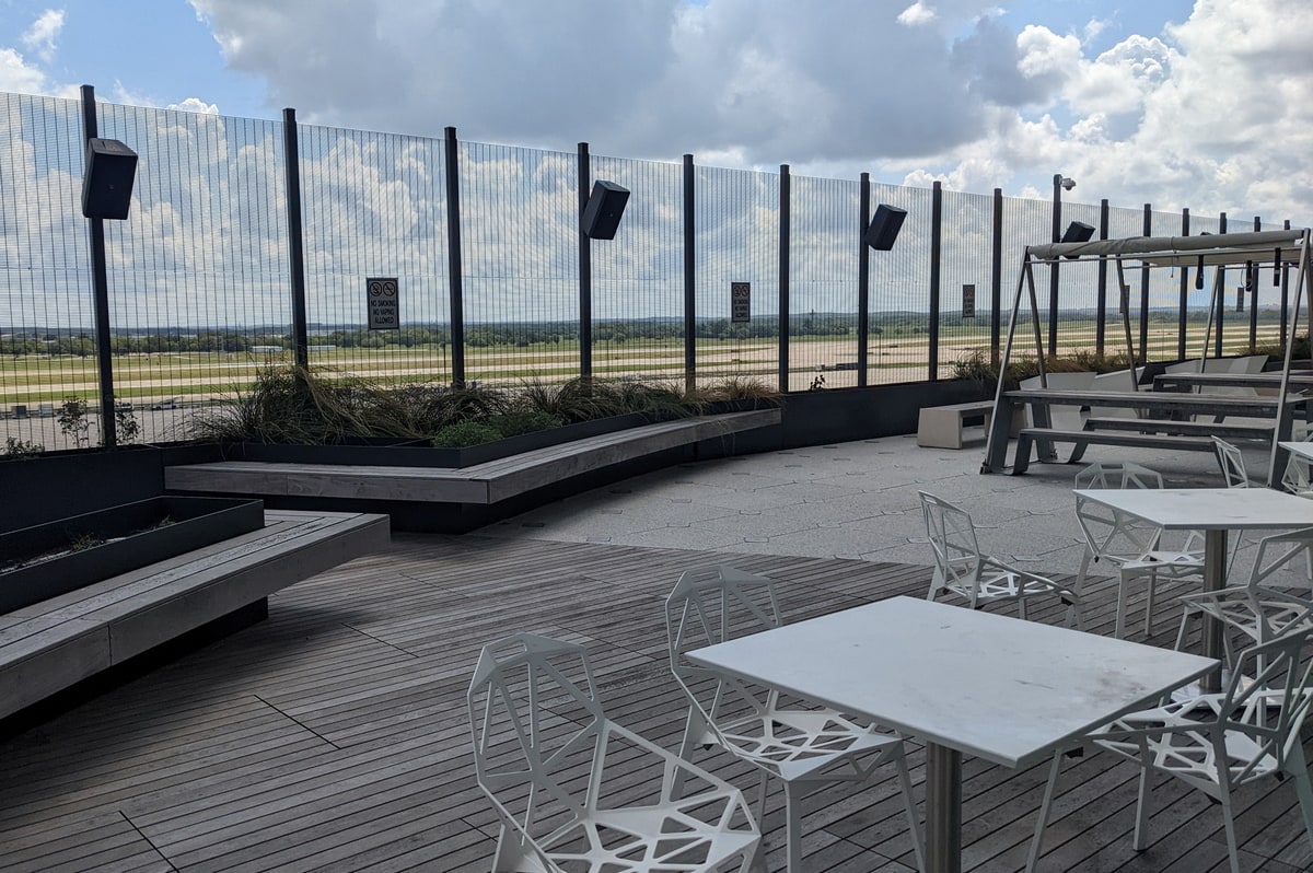 Ourdoor patio with a wood deck and views of the runway.