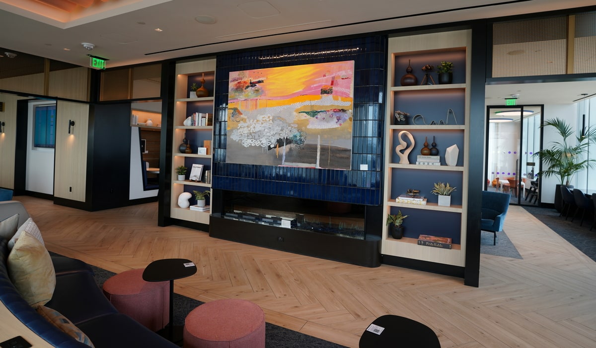 view inside the lounge of the fireplace, seating, and art.