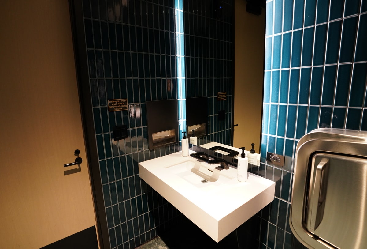sink area with a baby changing table, inside of the private restroom.