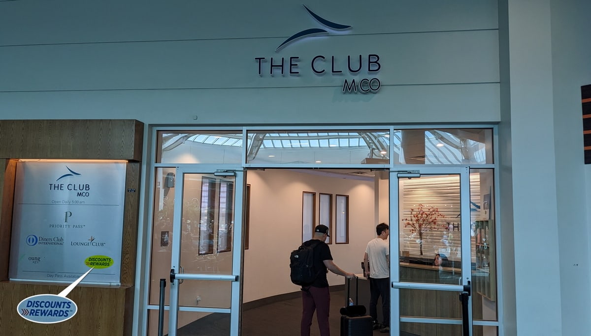 Entrance to The Club lounge in Orlando, with a sign showing Discount Rewards.