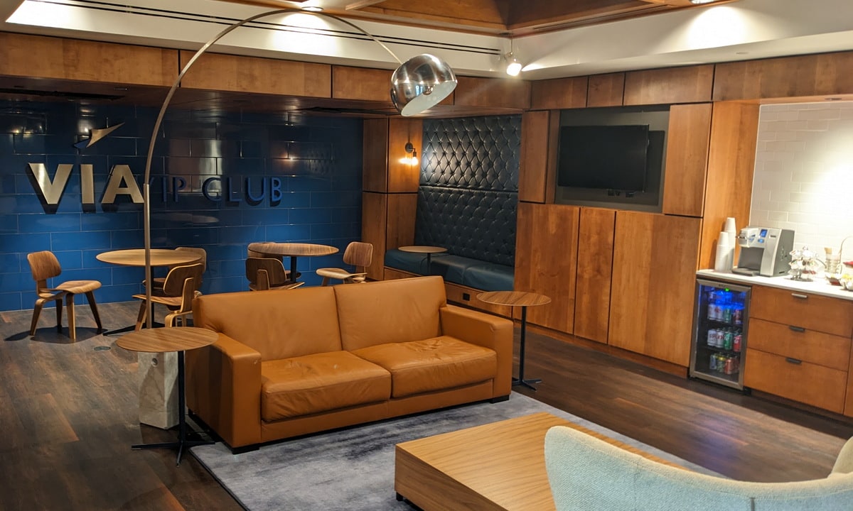 seating area, with tables and chairs, also a TV in the background.