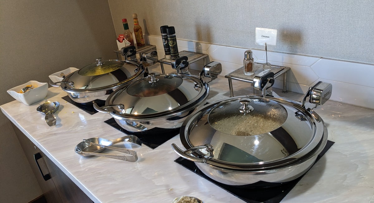 breakfast food buffet with three containers or warm food.