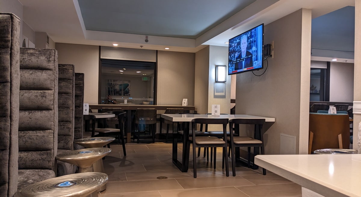 seating areas with tables and TV