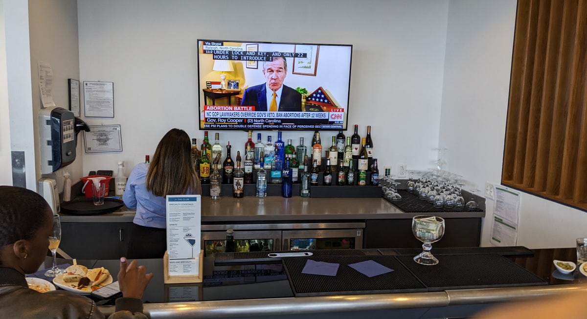 Bar area with seating a TV in the background.