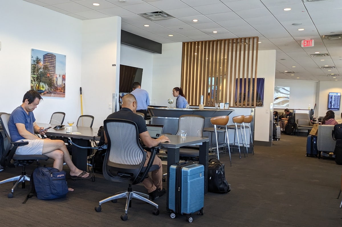 Conference table and seating area, located near the bar.