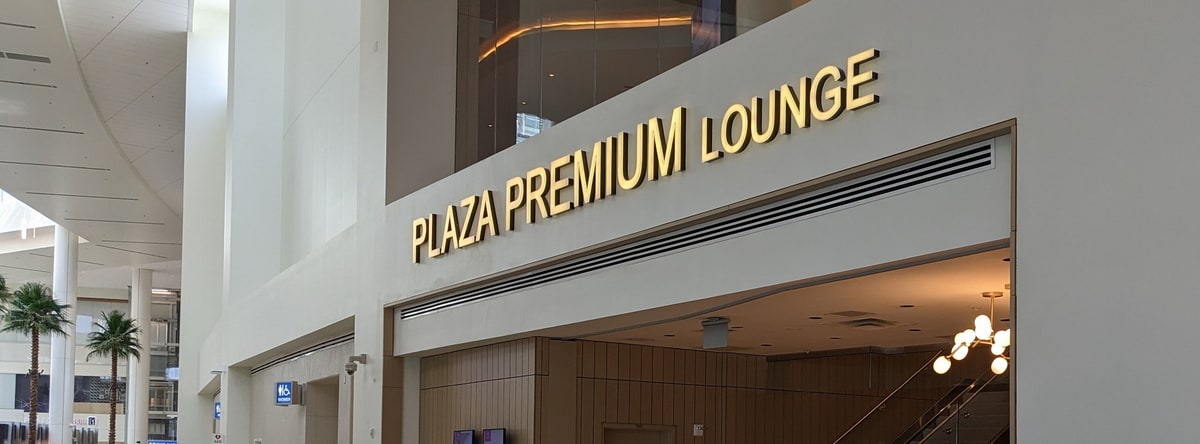 Entrance to the Plaza Premium lounge in Orlando, showing the gold letters for logo.