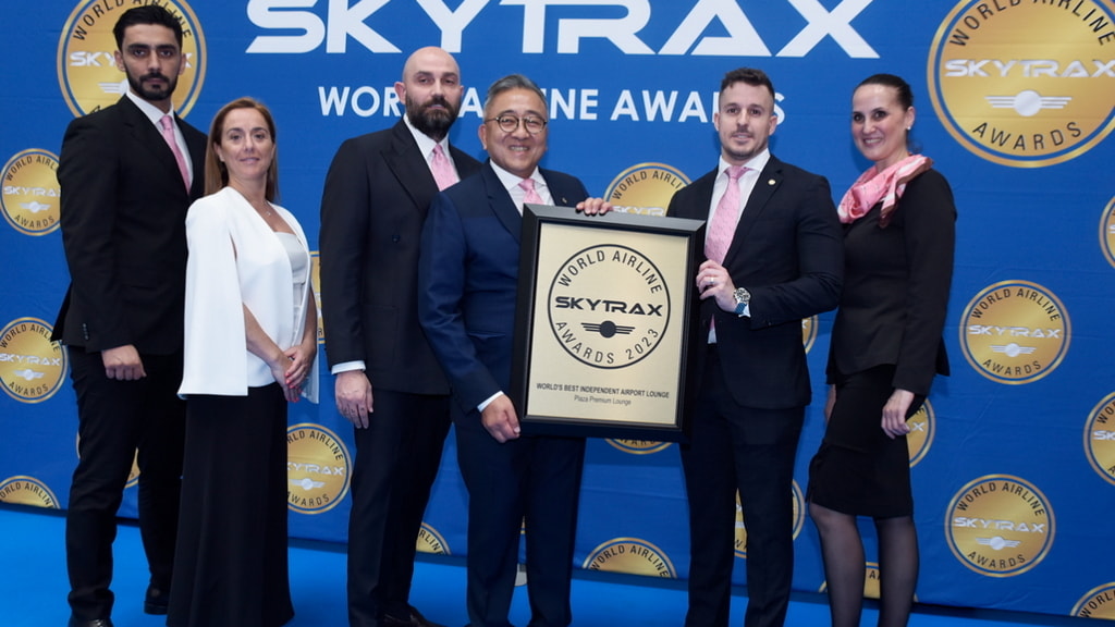 Six people standing on stage to accept an award for the Best Independent Lounge award.