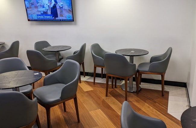 dining area with tables and TV on the wall.