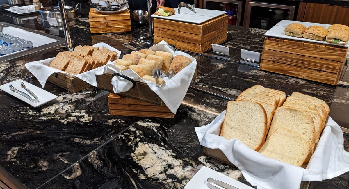 food area with bread and sandwiches, in a self-serve area.