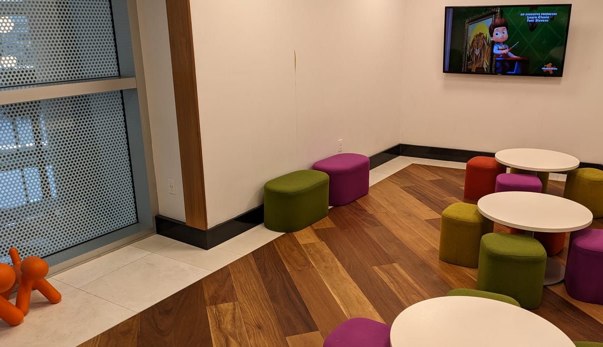 Kids area with toys, tables and a TV.