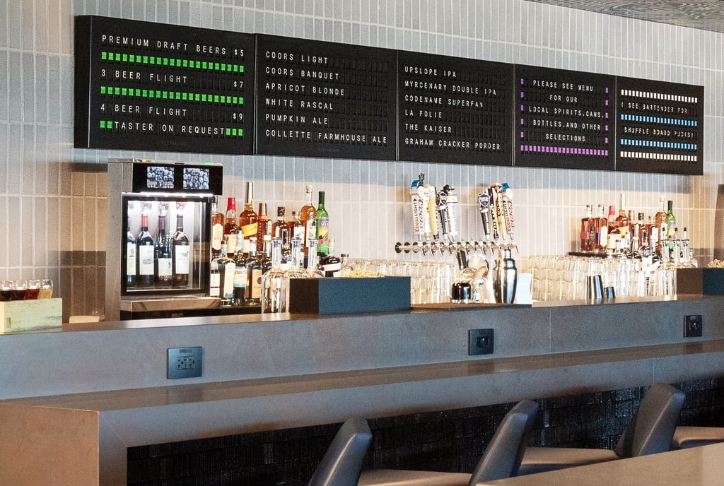 bar area with a digital menu in the background.