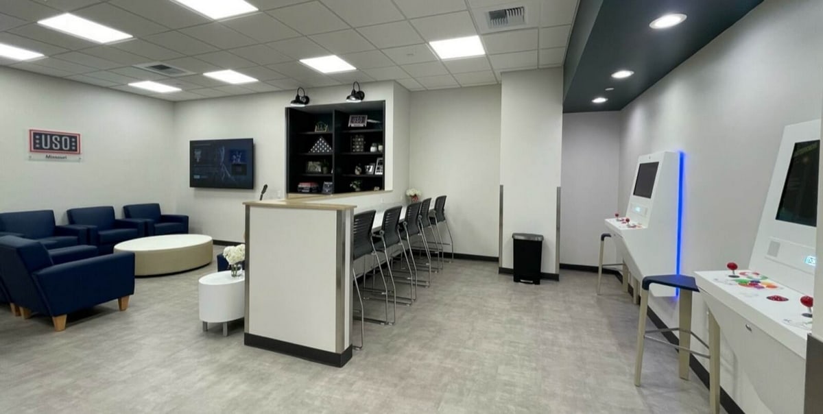 main area showing seating, tables, and games inside the MCI USO.