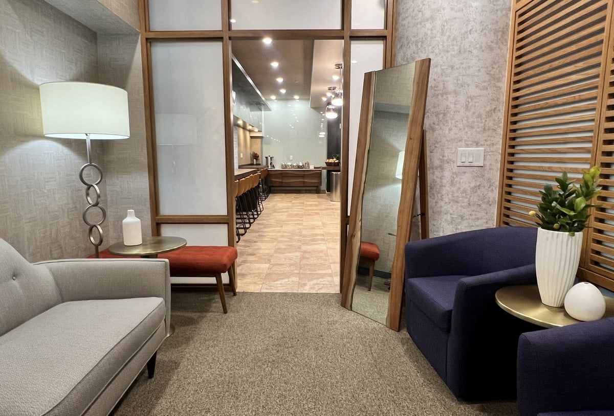 waiting room with sofas, and comfortable chairs.