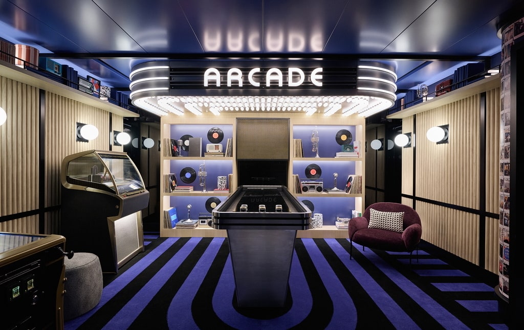 game room with pinball, jukebox, and other arcade games.