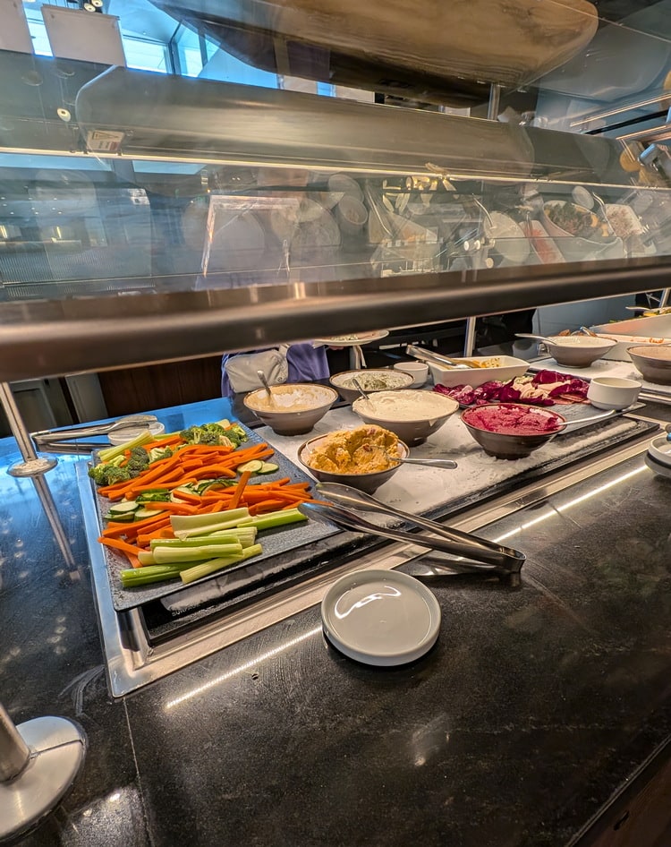 fresh veggies and cheese on the buffet area.