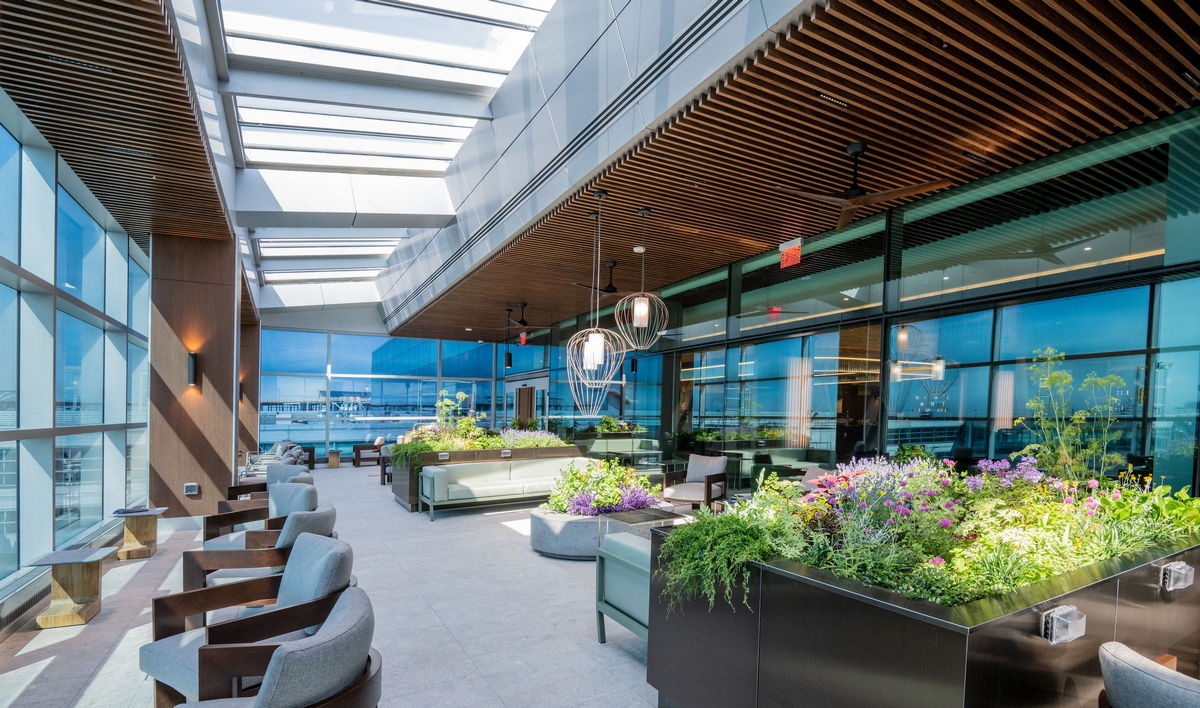 patio area, with seating and windows showing airport area.