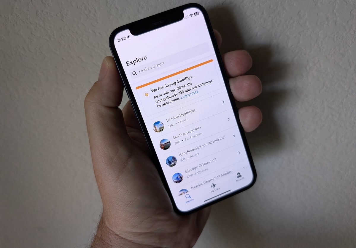 the LoungeBuddy iOS app being held in the hand with a message saying it will no longer be working after July 1, 2024.