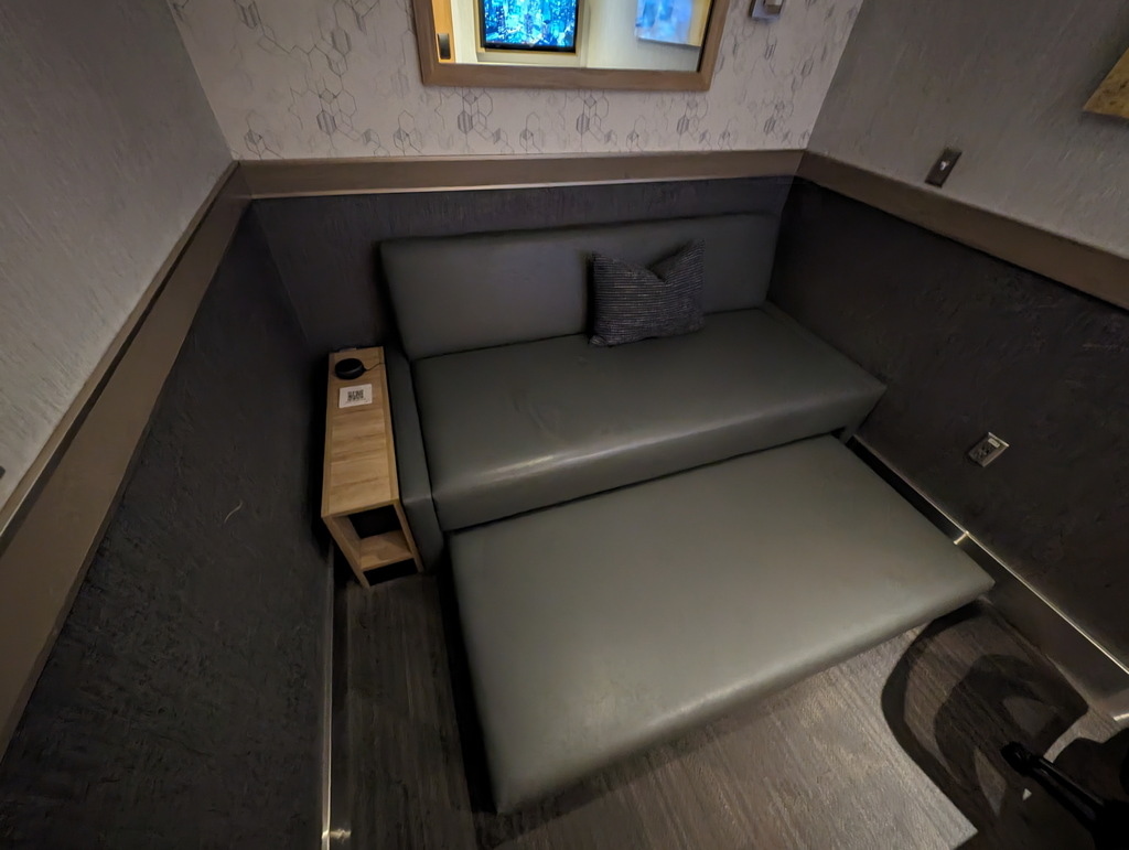 view of the pull-out sofa bed and side-table.
