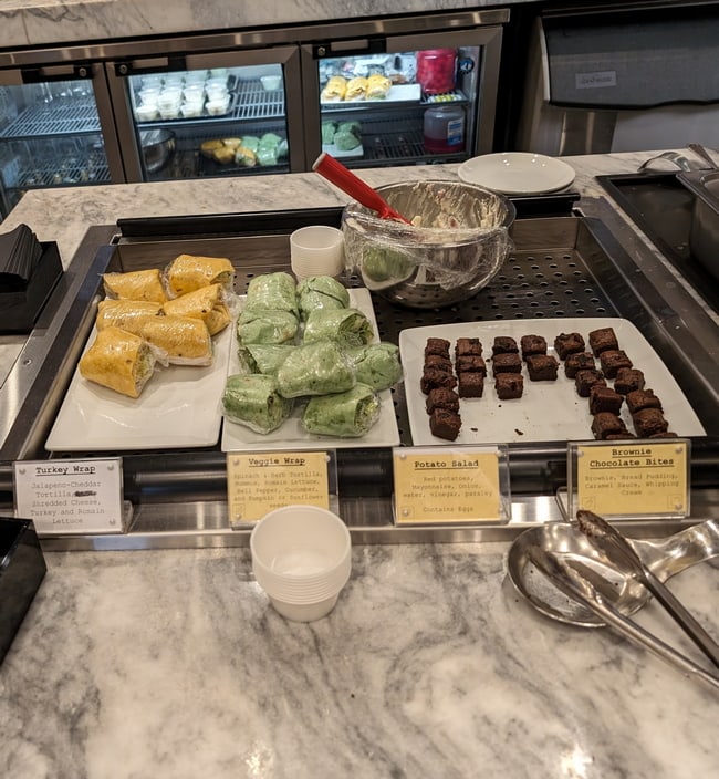 Food area with wraps and brownies.