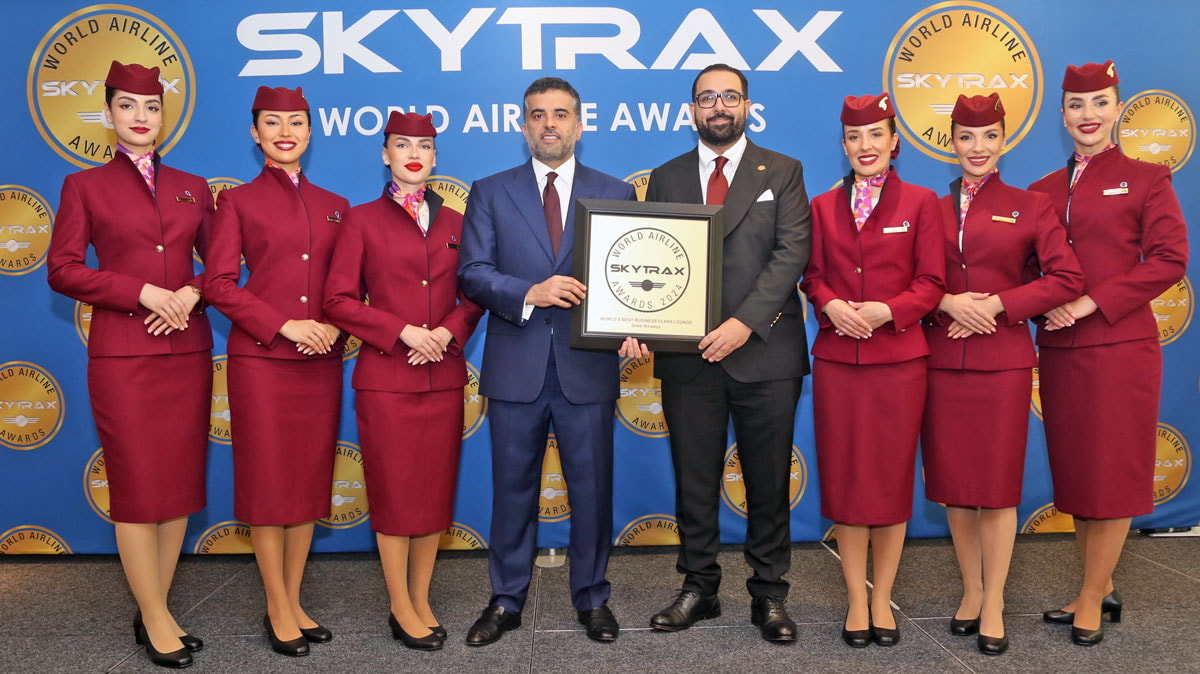 seven people standing on stage with the award for best business class lounge.