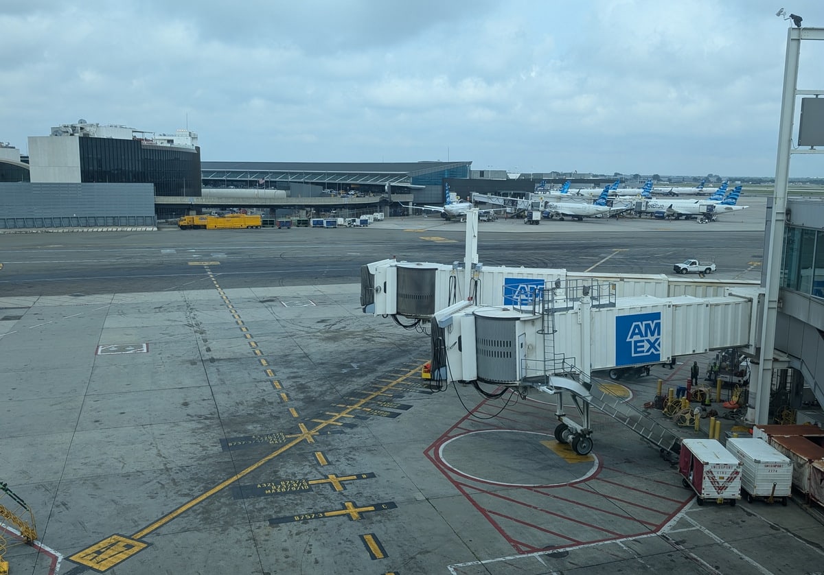 View outside of the lounge of Terminal 5 and the TWA Hotel with planes and gates.