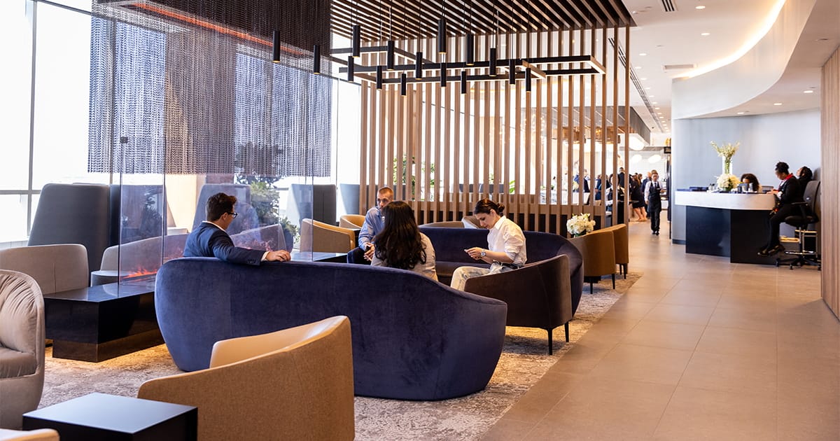 Lounge with a central area and people sitting.