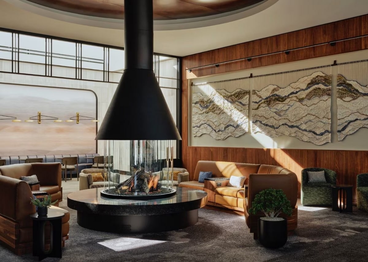 Seating area with sofas around an indoor fireplace.