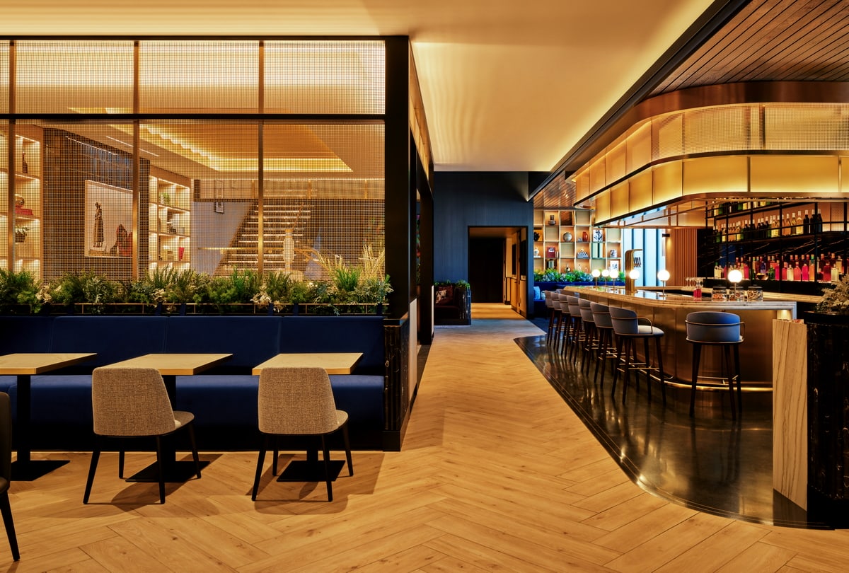 Bar area with seating at the bar and nearby tables.