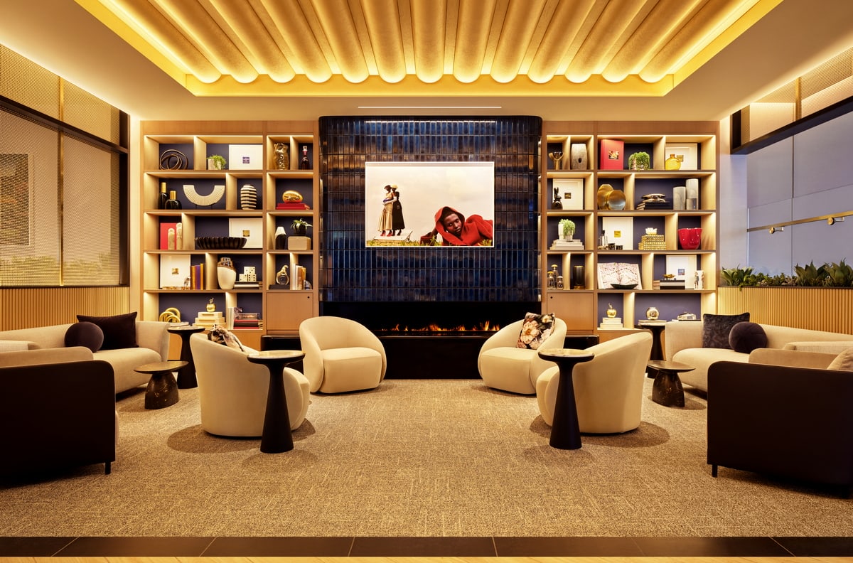 Relaxation area with sofas, charis and small tables near a fireplace.