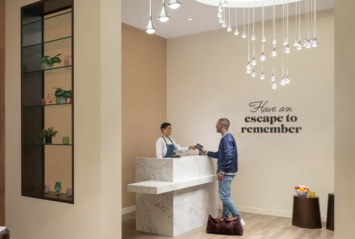 Lounge entrance and a reception desk with customer talking to lounge employee.