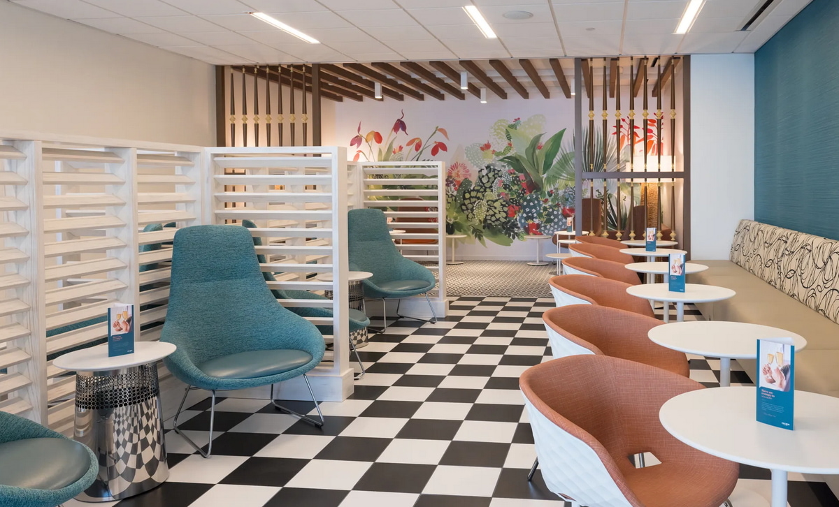 Main seating area inside of the Escape lounge San Juan, showing charis and tables.