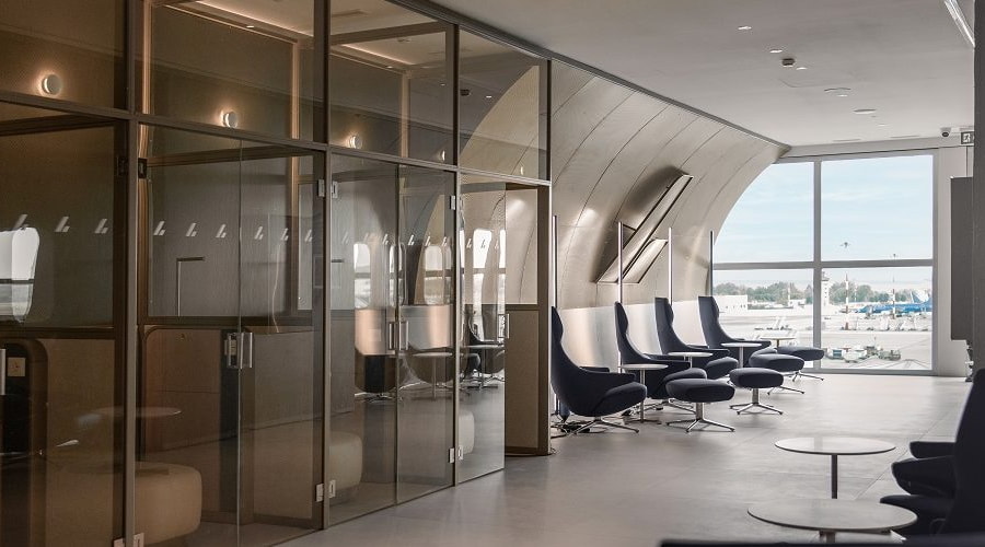 isolated phone booths, with seating area, large windows in the background.