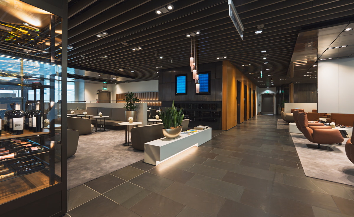 Central seating area with chairs, tables, and windows.