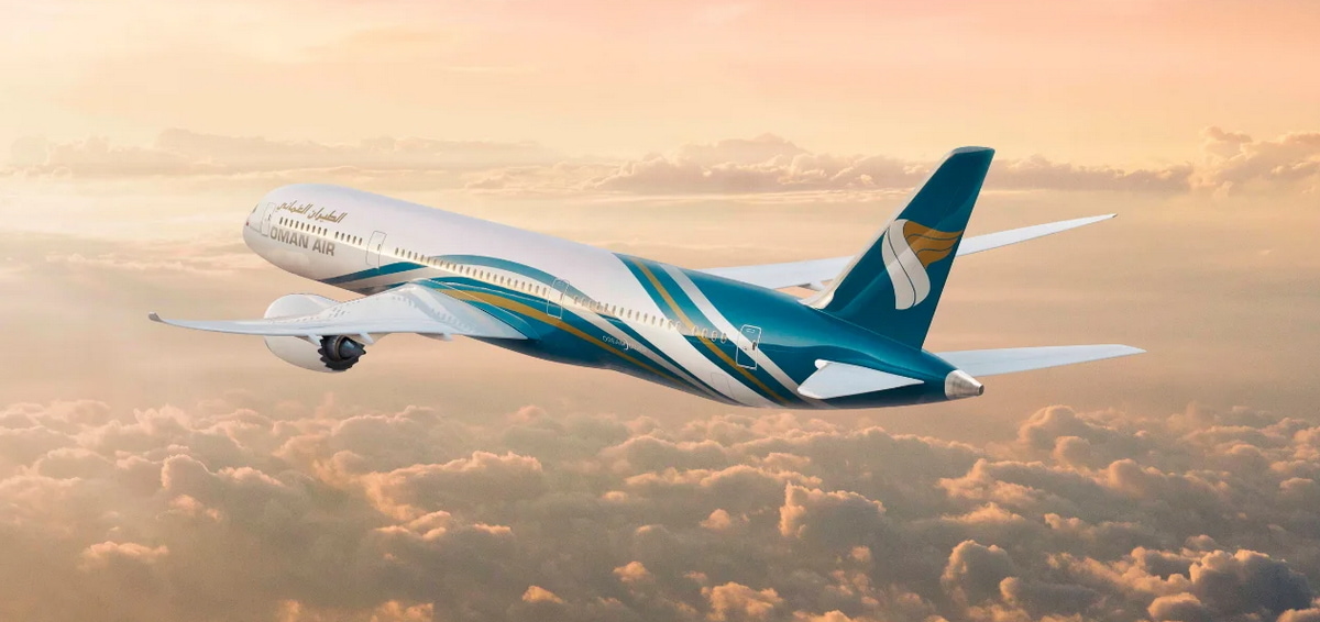 Oman Air 787 flying with clouds below.