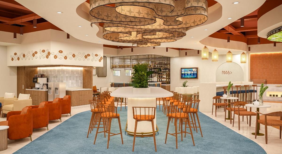 Seating area with chairs, tables and bar in the background.