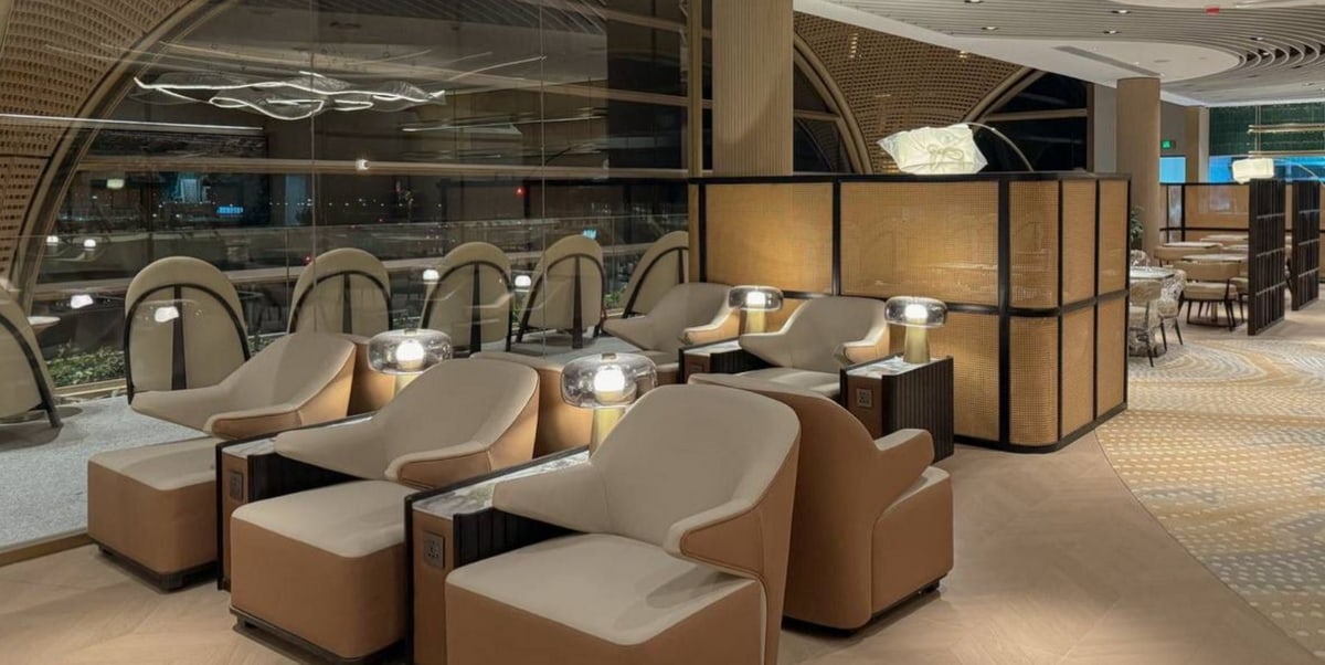 Seating area with chairs, charging ports, and small tables.