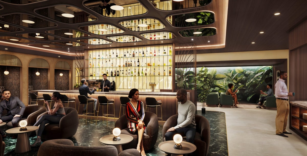 seating area with tables and bar in the background.