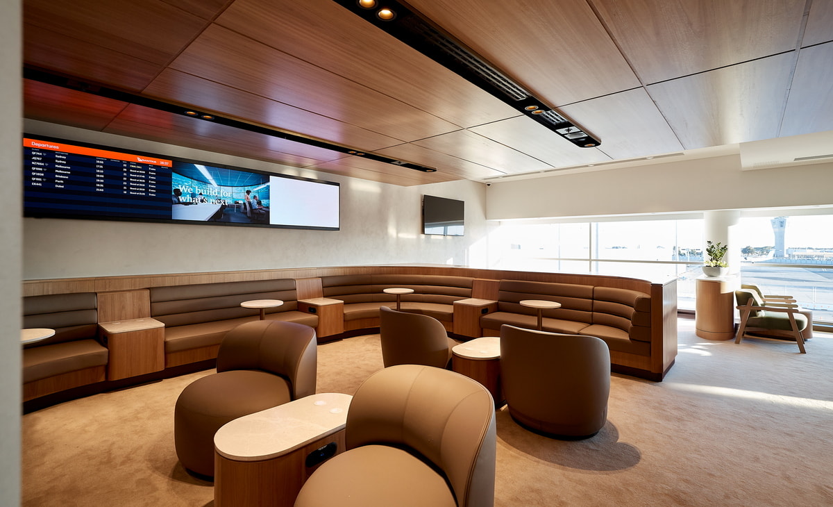 seating and chairs, with TV and windows in the background.