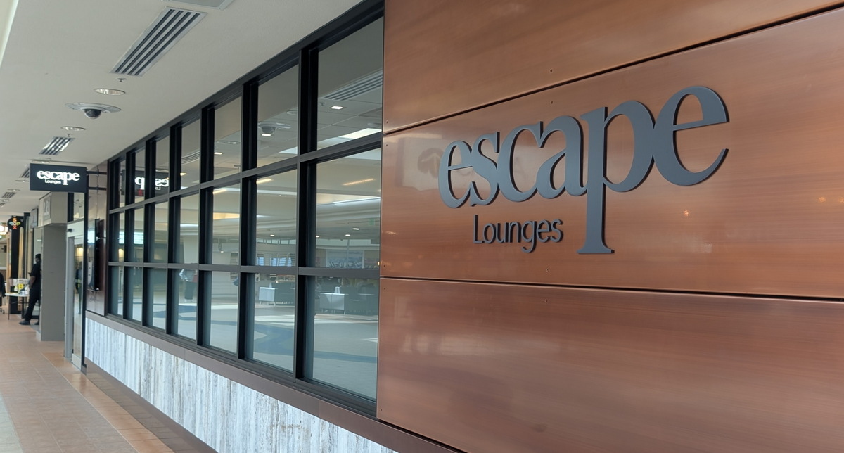 The front view of the Escape Lounge, featuring a wood panel and several windows.