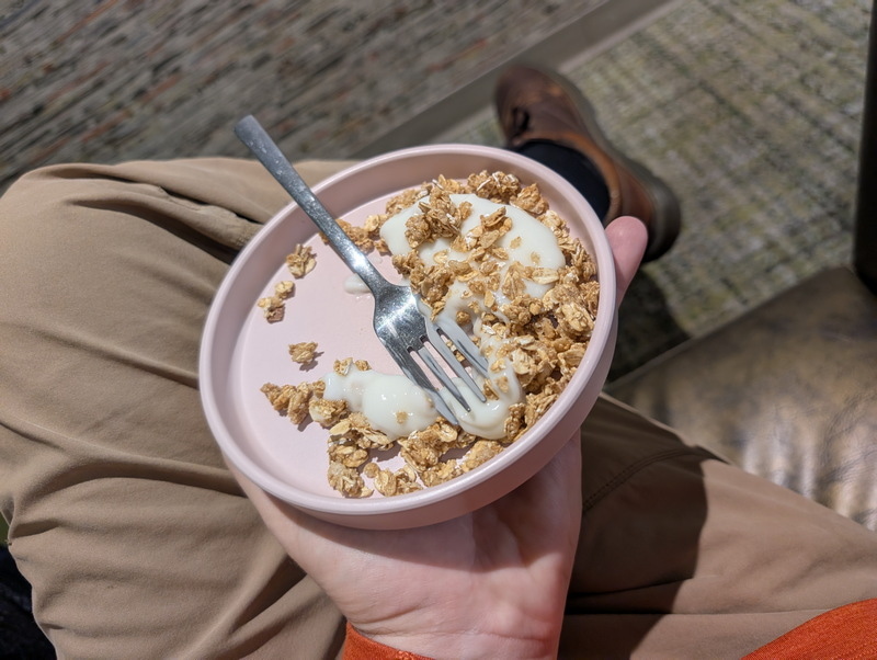 holding a bowl of granola.